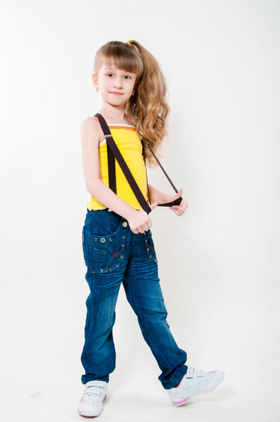 Little girl in jeans on a white background - Foto, Imagem