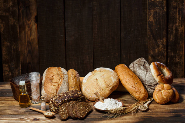 Fresh assorted loaves of gluten-free bread on wooden table - Фото, зображення