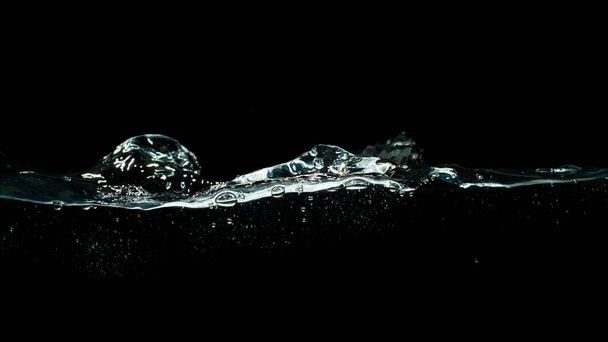 salpicadura de agua aislada sobre fondo negro oscuro - Foto, Imagen