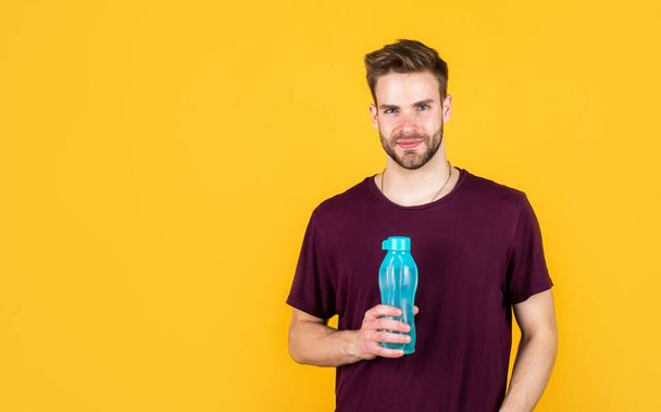 Hydrate copy space. man drink water after active training. handsome guy hold water bottle. hydration and hydro-balance. sport and health. refreshing while fitness. water balance in body. healthcare - Fotó, kép