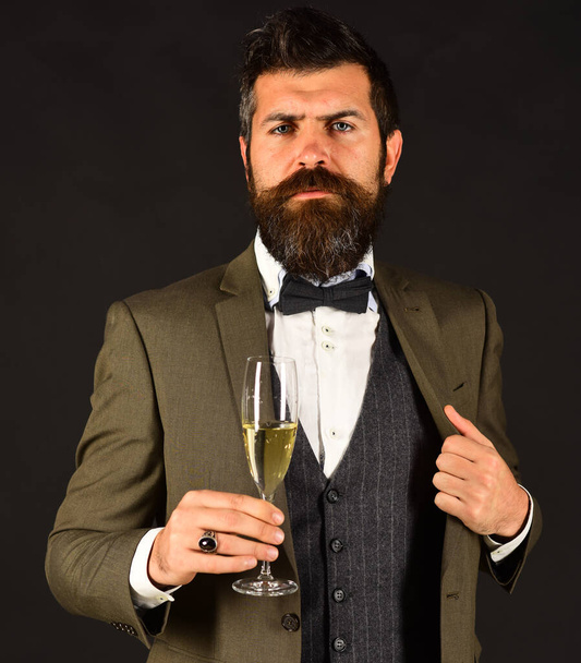 Corporate party concept. Man with beard holds glass of champagne - Foto, Imagen