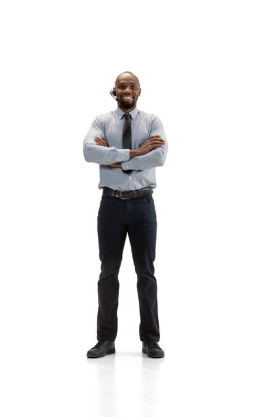 Young african-american call center consultant with headset isolated on white studio background - Φωτογραφία, εικόνα