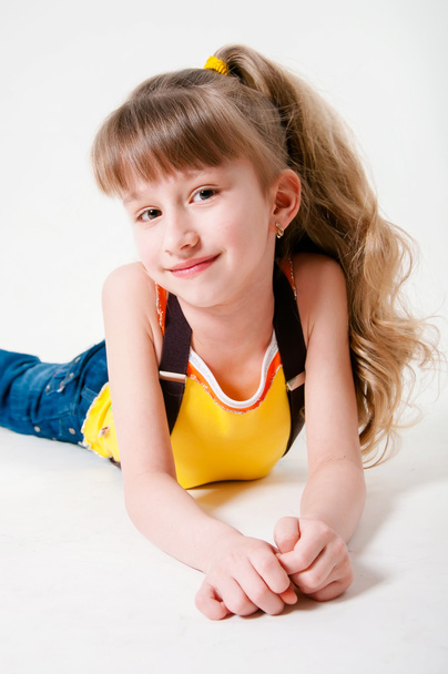 Little girl in jeans on a white background - Фото, изображение