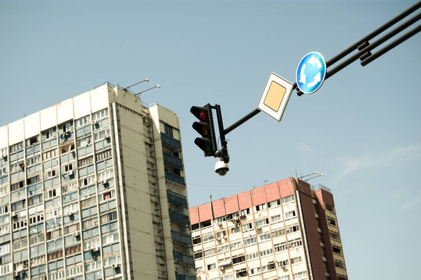 Traffic light and road signs with multistory buildings on the background. - Φωτογραφία, εικόνα