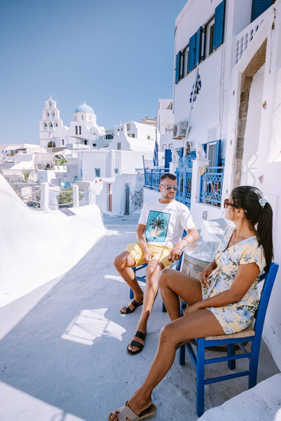 Pyrgos, Santorini, Greece. Famous attraction of white village with cobbled streets, Greek Cyclades Islands, Aegean Sea couple on vacation Santorini Greece - Photo, Image