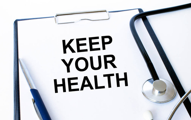 Text Keep your Health on a sheet in the medical folder with a phonendoscope and pen - Φωτογραφία, εικόνα