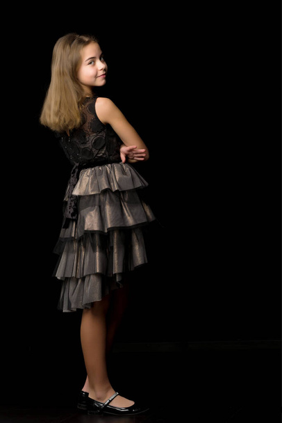 Fashionable girl teenager studio photo on a black background. - Fotoğraf, Görsel