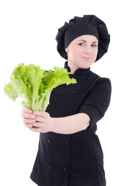 young cook woman in black uniform with green salad isolated on w - 写真・画像