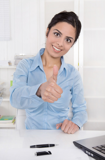 Successful smiling business woman with thumb up at desk at offic - Photo, Image