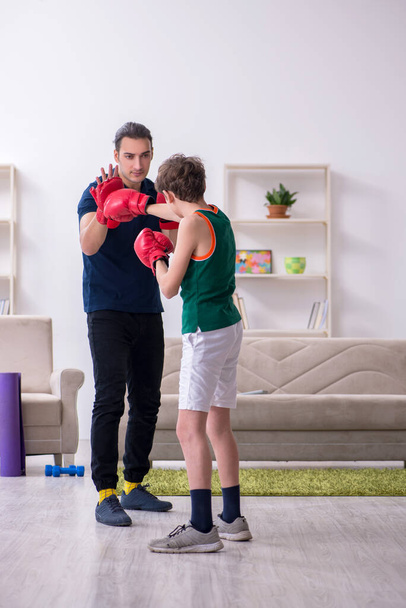 Father and son doing sport exercises indoors - Zdjęcie, obraz