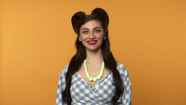 Excited pin up woman playfully winking at camera with smile - Footage, Video