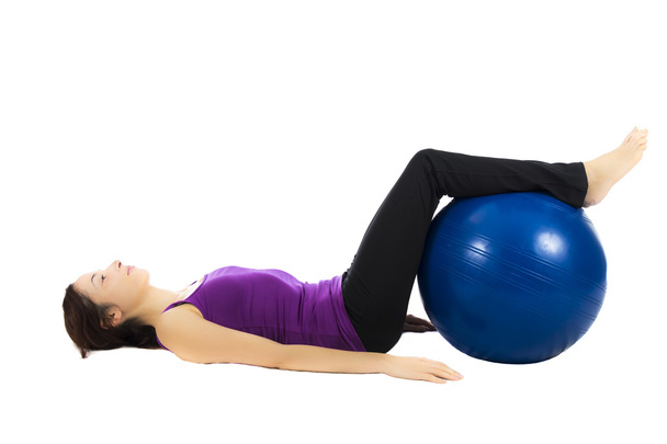 Young woman doing pilates ball exercises - Foto, immagini