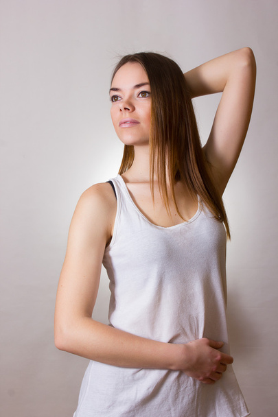Portrait of a beautiful young woman in a white T-shirt with natural make-up and straight brown hair - Fotoğraf, Görsel