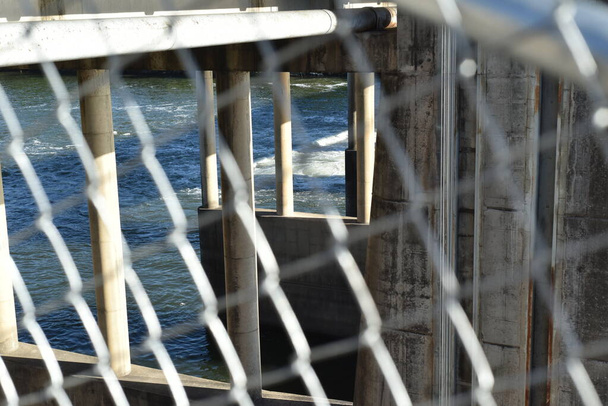 Lower dam through fence at the Colorado lake, Austin. The scene was taken at Austin, Texas, USA - Photo, Image