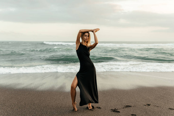 woman on beach is enjoying serene ocean nature during travel holidays vacation outdoors - Φωτογραφία, εικόνα