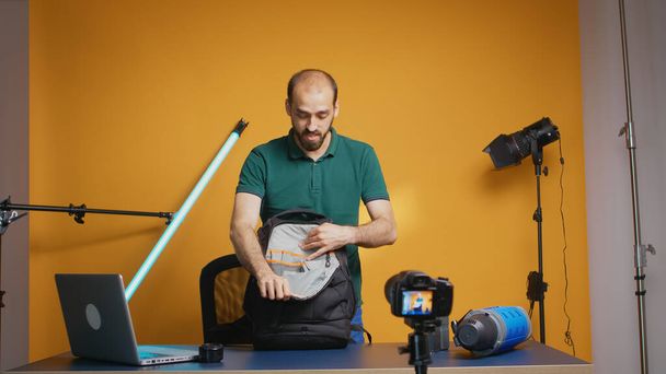 Protographer presenting gear backpack - Foto, afbeelding