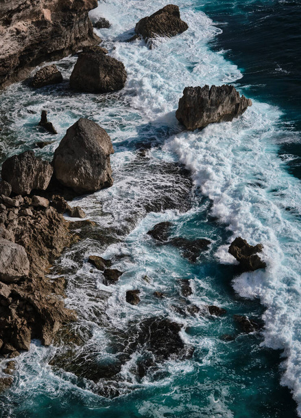 Aerial view to ocean waves with rocks. Blue water background. - Foto, imagen