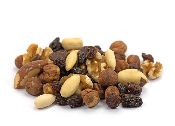 A mix of nuts and raisins against a white background - Photo, Image