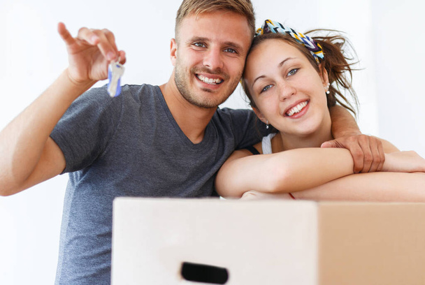 Couple showing keys of a new apartment. Moving in day - Photo, Image