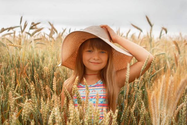Girl in a hat in a whead field - Photo, image