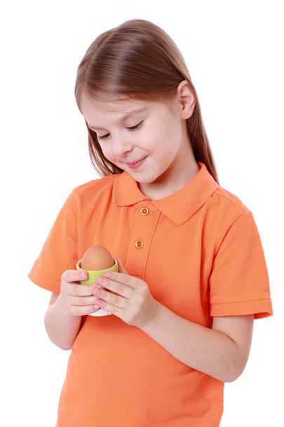 Little girl holding an egg - Foto, Imagen