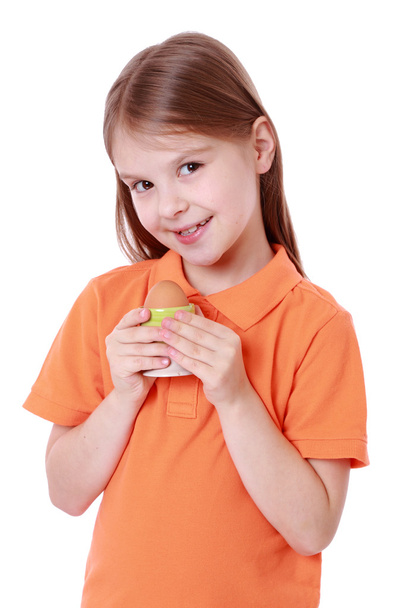 Little girl holding an egg - Фото, изображение