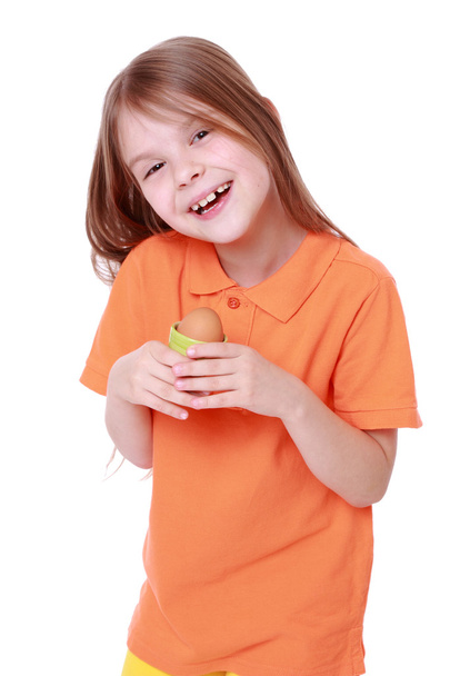 Little girl holding an egg - Foto, afbeelding