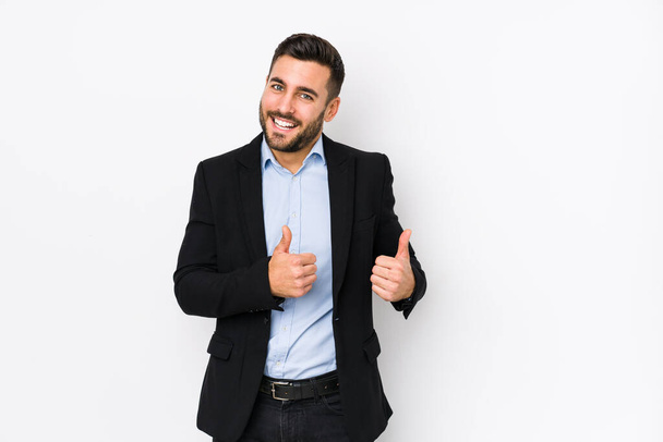 Young caucasian business man against a white background isolated raising both thumbs up, smiling and confident. - Fotó, kép