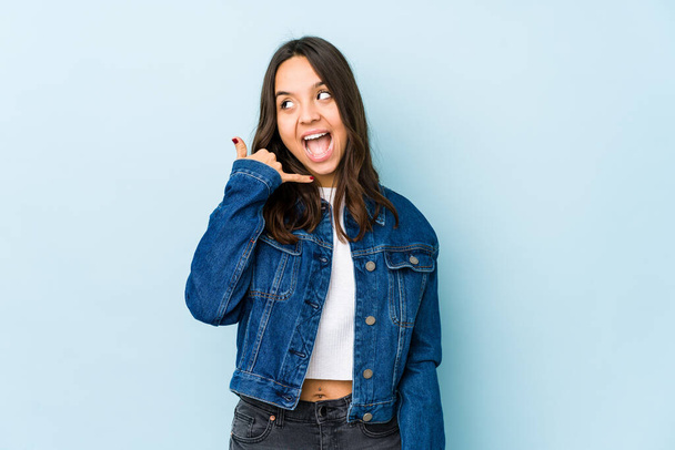 Young mixed race hispanic woman isolated showing a mobile phone call gesture with fingers. - Φωτογραφία, εικόνα