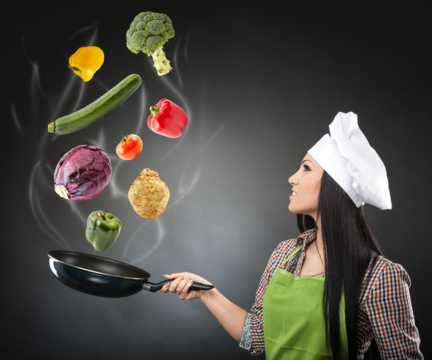 Skillful cook lady throwing veggies - Zdjęcie, obraz