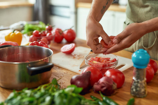 Close up of hands of man cook holding, preparing tomatoes for cooking healthy meal with vegetables in the kitchen. Italian cuisine concept - Foto, immagini
