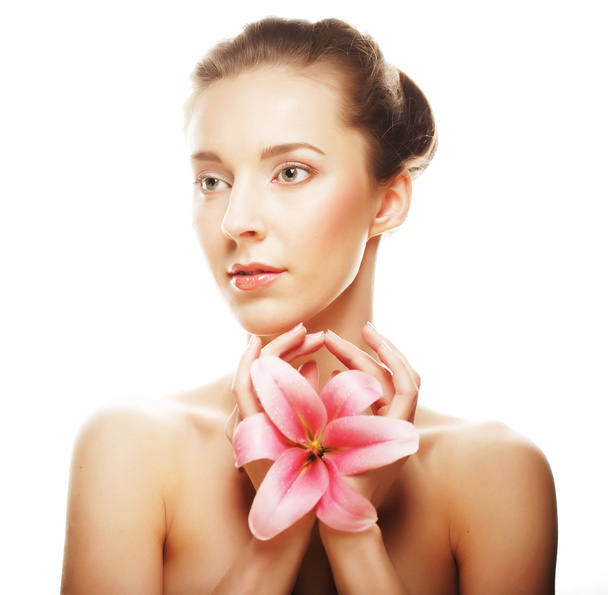 Beauty face of the young woman with pink lily - Photo, Image