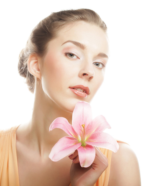 Beauty face of the young woman with pink lily - 写真・画像
