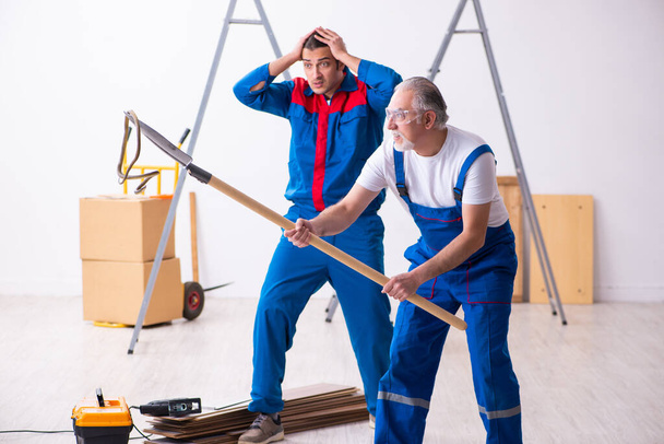 Two contractors and snake indoors - 写真・画像