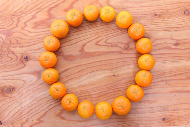 citrus tankan circle on wooden background - Photo, Image