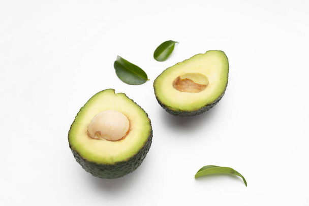 An avocado cut in half isolated on a white background - Foto, imagen
