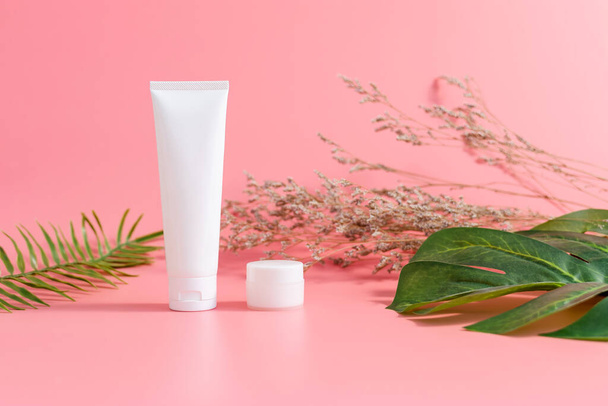 White bottle cream, mockup of beauty product brand on the pink background. - Fotó, kép