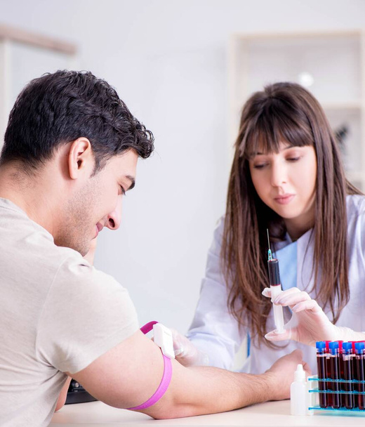 Paciente durante el procedimiento de toma de muestras de sangre para su análisis - Foto, imagen