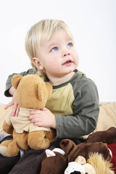 Preschooler with his soft toys - Foto, immagini