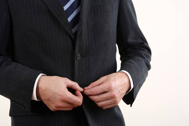 businessman unbuttoning suit, close up - Foto, Imagen