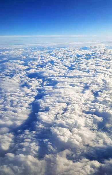 A beautiful scenery of the earth and white clouds seen from a plane - Fotoğraf, Görsel