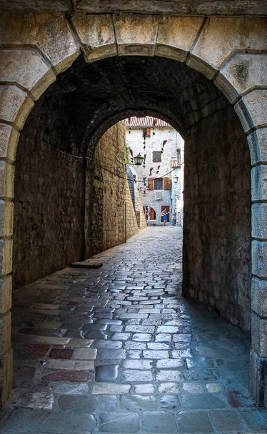 An alley way in the old town of Kotor, with flying brooms in the background, Montenegro - Zdjęcie, obraz