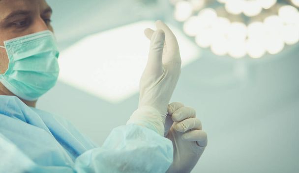 Man surgeon at work in operating room - Фото, изображение