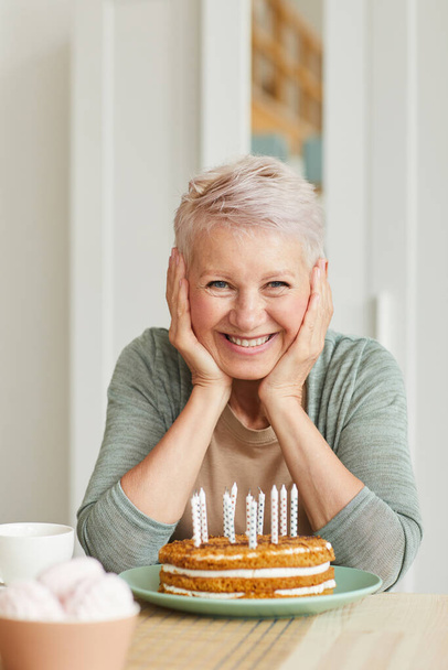 Senior woman with cake - Photo, Image