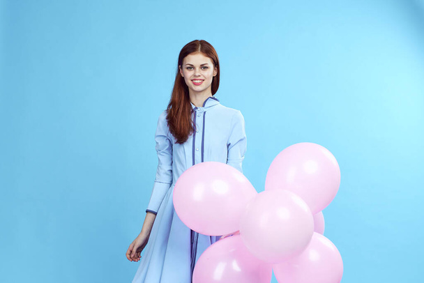 Beautiful woman with pink balloons holiday fun birthday Gift happiness blue background - Foto, afbeelding