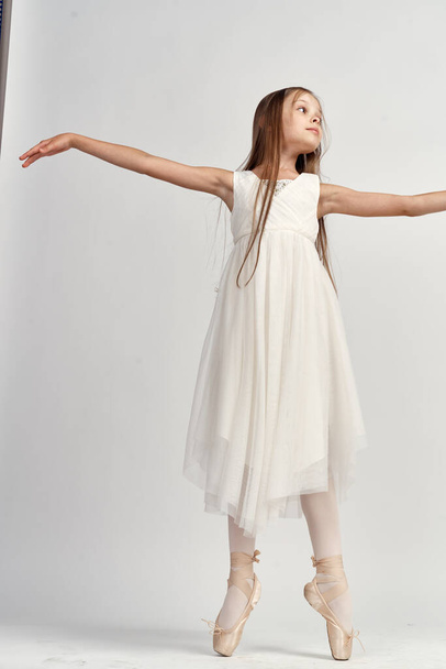 Girl ballerina in a light suit in full growth pointe shoes model dance - Photo, Image