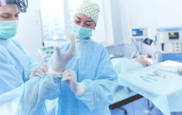 Man surgeon at work in operating room - Fotó, kép