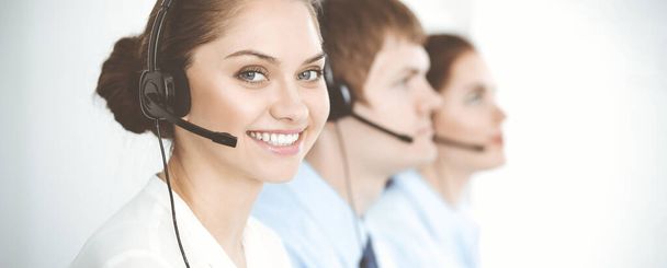 Call center. Diverse customer service operators in headsets at work in office. Business concept - Фото, изображение