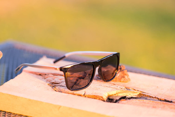 Modelo de gafas de sol clásicas con lentes negras que disparan en un día de verano. Enfoque selectivo - Foto, imagen
