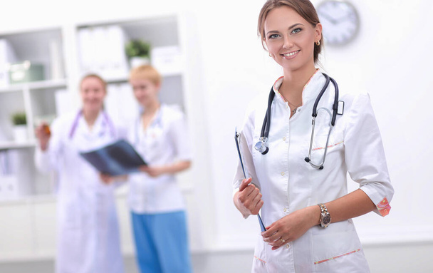 Young woman doctor standing at hospital with medical stethoscope - Φωτογραφία, εικόνα